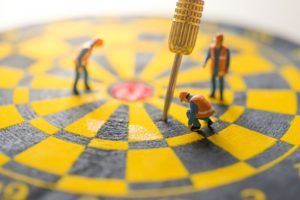 image of a dart board with people looking at the dart