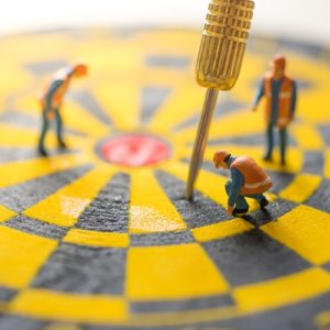 image of a dart board with people looking at the dart