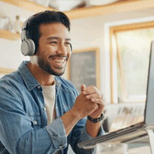 Man behind a computer interacting with people online