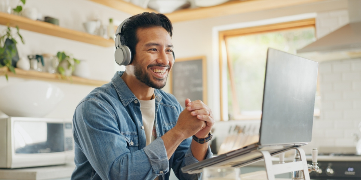 Man behind a computer interacting with people online