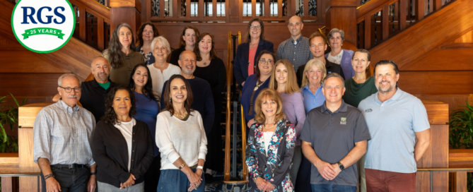 Photo of RGS staff with the RGS 25th Anniversary Logo