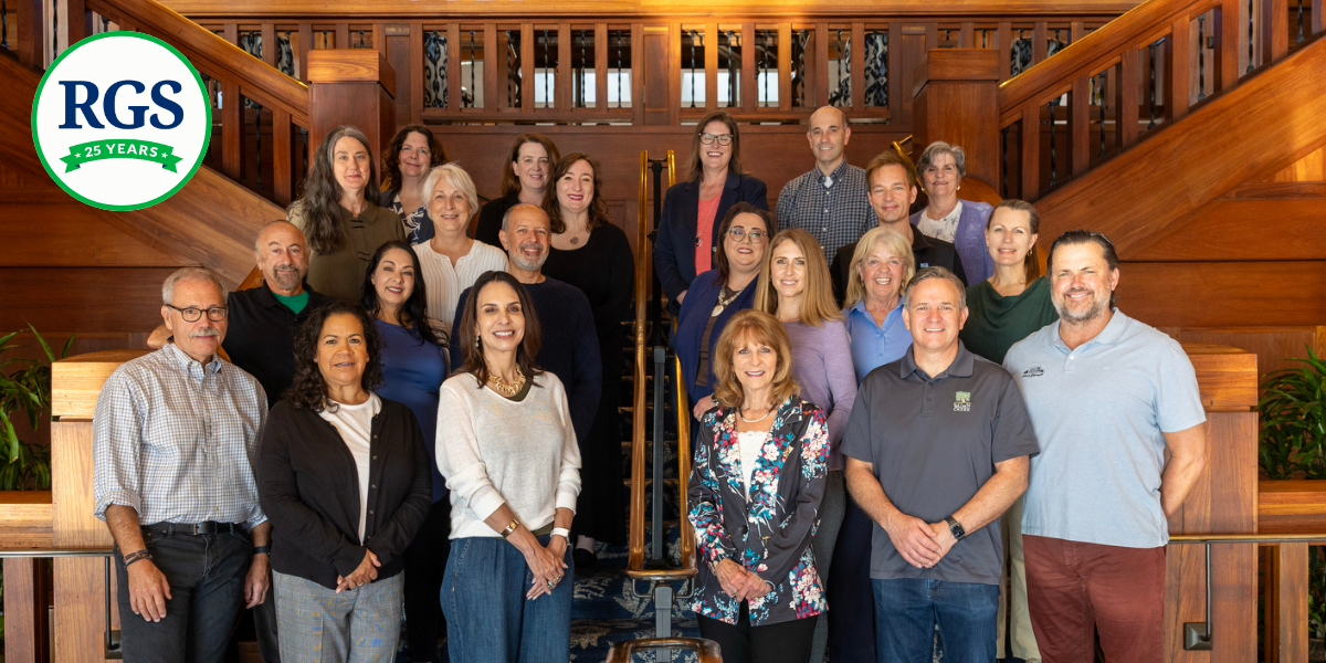 Photo of RGS staff with the RGS 25th Anniversary Logo